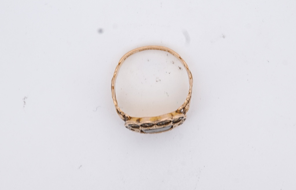 A William IV 18ct gold and black enamel 'In Memory' mourning ring, with hair beneath a central glazed panel, size N, gross weight 2.8 grams.